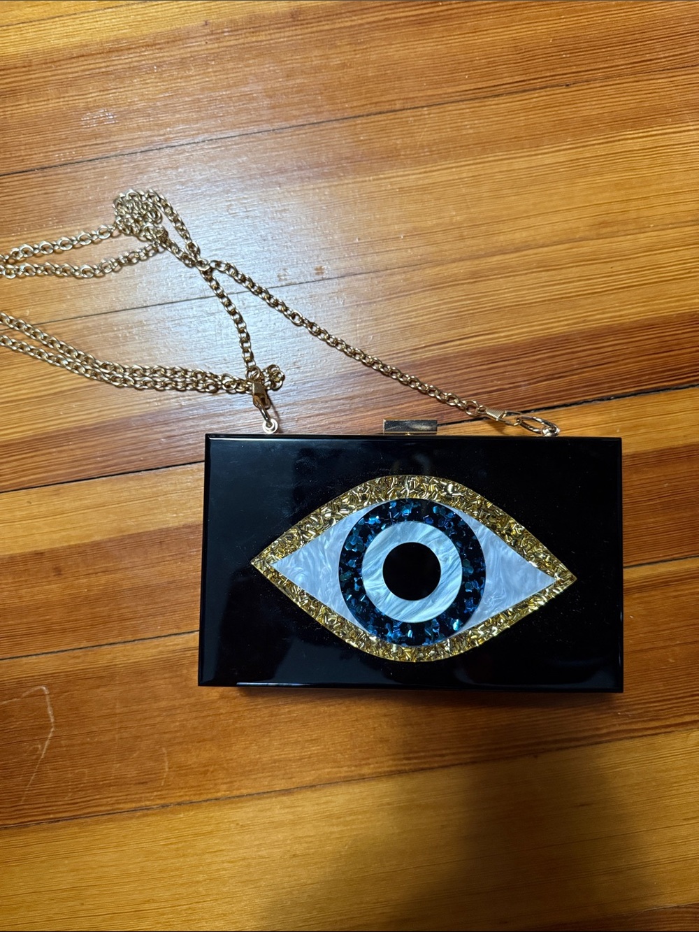 Black Eye-Embellished Crossbody Clutch with Gold Chain